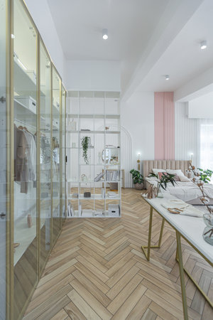 fashionable dressing room with glass doors with gold trim in a spacious open-plan apartment with a stylish modern bright design on a sunny dayの写真素材