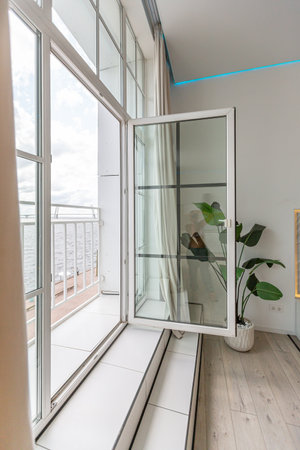 minimalistic modern luxury design of an expensive house with marble trim on a sunny day. white walls with plaster, parquet, decorative lighting and no one insideの写真素材