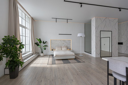 minimalistic modern luxury design of an expensive house with marble trim on a sunny day. white walls with plaster, parquet, decorative lighting and no one insideの写真素材