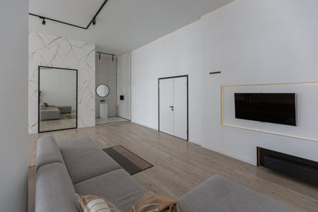 minimalistic modern luxury design of an expensive house with marble trim on a sunny day. white walls with plaster, parquet, decorative lighting and no one insideの写真素材