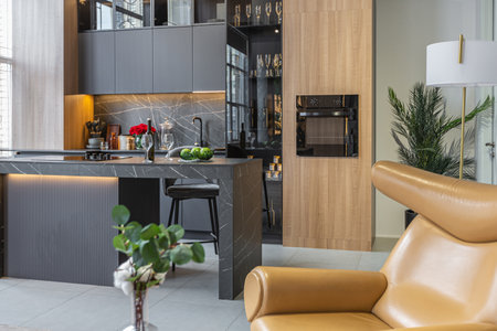 wood decorated dark kitchen area with coocking island in huge modern spacious apartment with high...