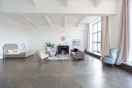 Modern luxury stylish apartment interior in pastel colors. a very bright room with huge windows filled with daylight. white walls, wooden parquet floors and a dark marble fireplaceの写真素材