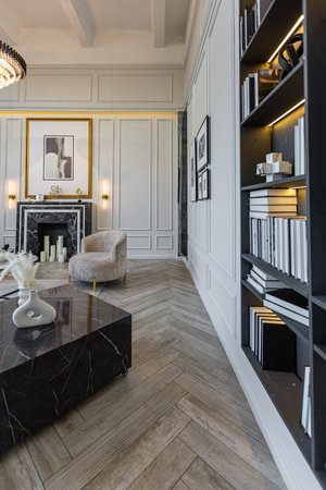 modern living room in a historical style with a marble fireplace in a chic expensive bright interior...