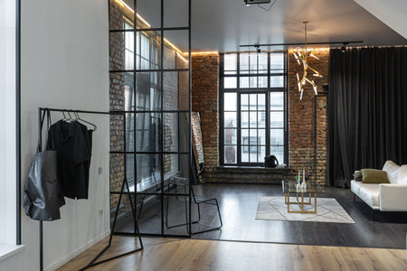 minimalistic stylish interior of luxury apartment with white stylish bedroom and dark living room. modern apartments with an open layout during the day without people and amazing sun raysの写真素材