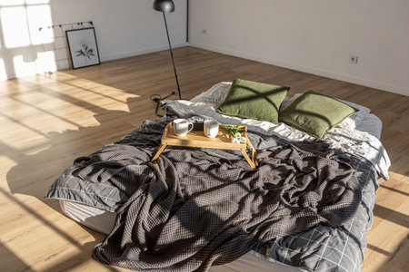 minimalist stylish interior of white simple bedroom with window in ceiling and sun rays without...