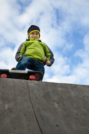 Young happy skater training on the tableの写真素材