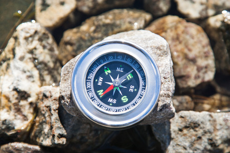 Analogic Compass Abandoned on the stone in the summerの写真素材