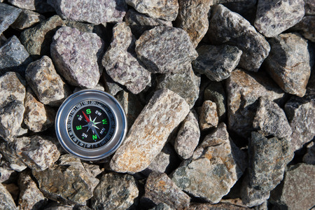 Analogic Compass Abandoned on the stone in the summerの写真素材