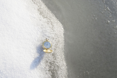 Watch lying in the snow before the new year. For Christmas, New year holidaysの写真素材