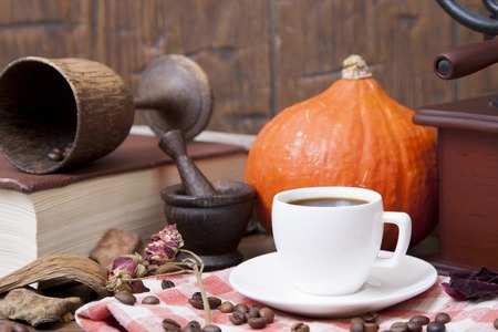 White cup of coffee on the autumn background.の写真素材