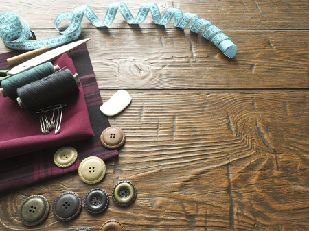 Sewing accessories  in a wood background.
