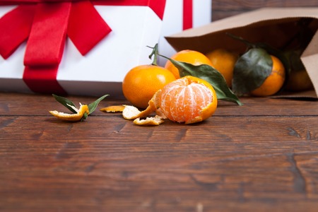 Christmas mandarin orange pouring out of  vintage paper sack.の写真素材
