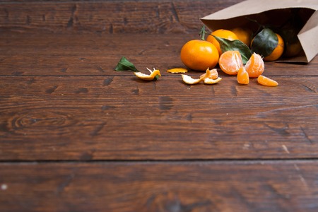 mandarin orange pouring out of  vintage paper sack.の写真素材