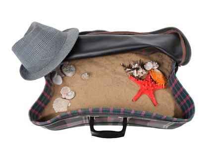 retro suitcase with accessories on beach, isolatedの写真素材