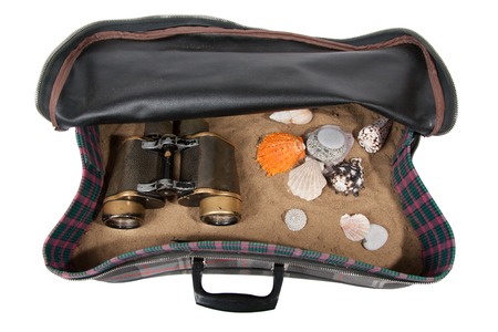 retro suitcase with accessories on beach, isolatedの写真素材