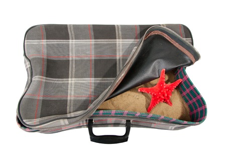 retro suitcase with accessories on beach, isolatedの写真素材