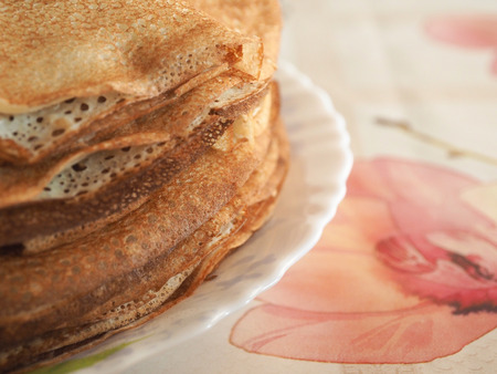 Russian domestic thin pancakes on a plate.