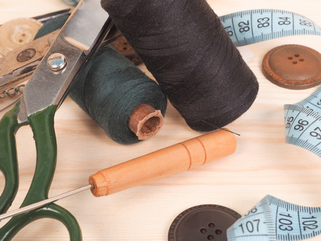 Sewing accessories in a wood background. sewing concept.