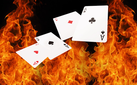 4 Playing cards on fire. casino concept