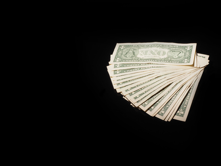 dollar bill on a black background . finance