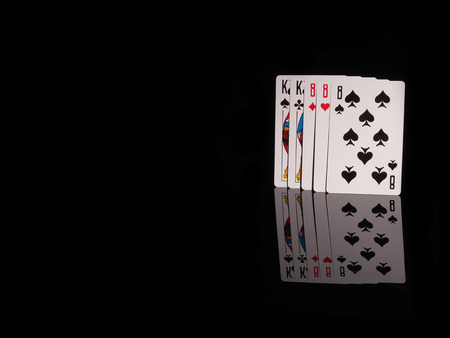 Full House playing cards isolated on black background. casino conceptの写真素材