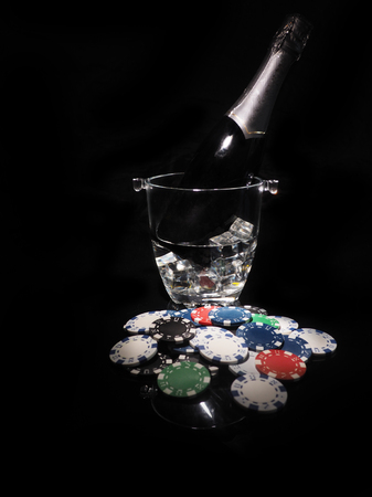 Playing cards and a bottle of champagne in bucket.の写真素材