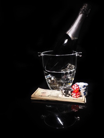 Playing cards and a bottle of champagne in bucket.の写真素材