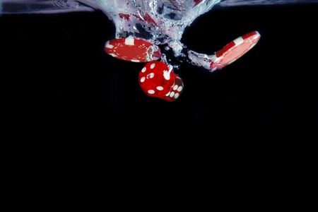 Red dice fall into the water. Casino concept.の写真素材