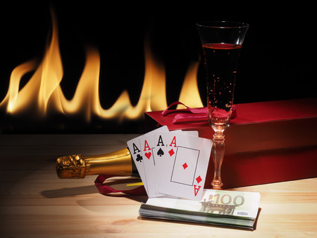 Playing cards and a bottle of champagne in box.