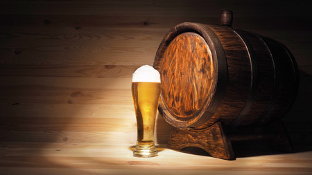 Beer mugs and barrel on a wooden background.の写真素材