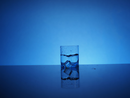 Glass of mineral clear water with ice.の写真素材