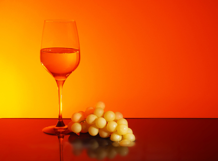 Glass of White Wine on Sunset backgraundの写真素材