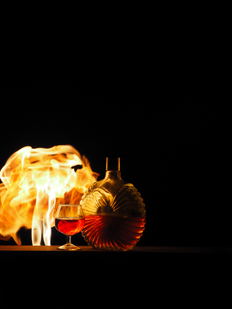 Cognac with a fire on a black background.の写真素材