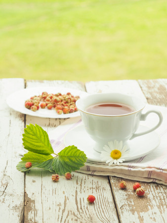 White cup of tea on a wooden tableの写真素材