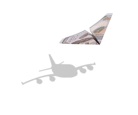 One hundred dollar paper airplane with a natural airplane shadow.の写真素材
