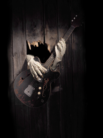 Zombie hand through hole cracked in rustic wood.Halloween theme.の写真素材