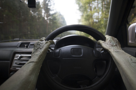 The hands of zombies and the steering wheel of a car.の写真素材