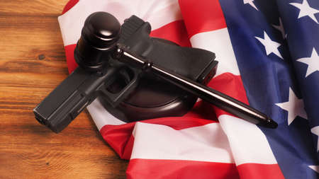 Judge gavel and gun on USA flag. Gun law conceptの写真素材