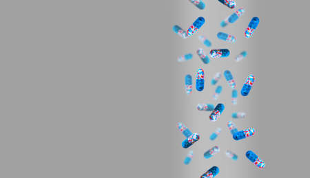 Colored pills are falling against a colored background. Medicine and healthcare concept