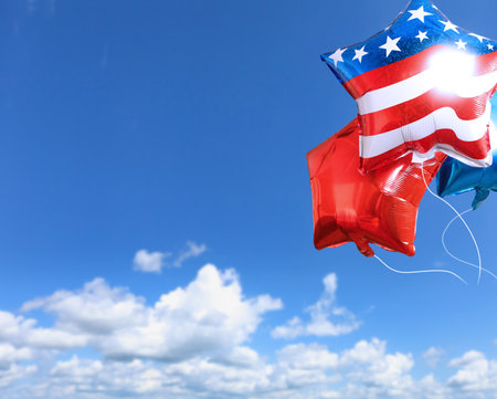 The balloons with USA flag on blue sky background. American holiday concept.の写真素材