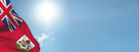 Flag of Bermuda on sky background. National holiday concept. British Commonwealthの写真素材