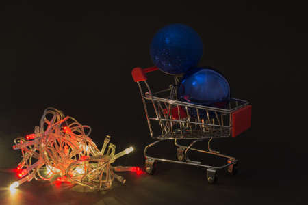 on a black background in low key, trolley from the supermarket with purchases for Christmas, preparing for the holiday.Soft focusの写真素材