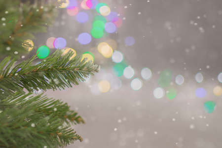 close-up of artificial spruce branches against the background of bokeh of Christmas lights. Photo artistically processed, soft focus. The concept is New Year's mood, expectation of a miracleの写真素材