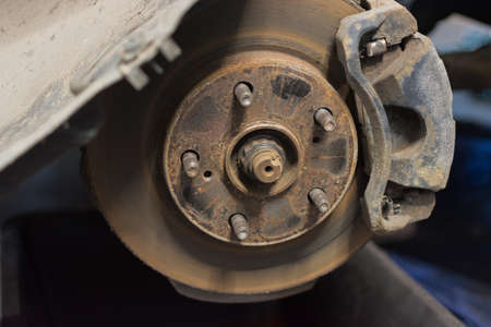 close-up of a car brake disc with brake calipers, rusty dirty, requiring replacement. Horizontal...