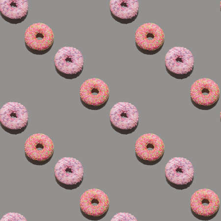 seamless pattern, pink round donuts on a gray background. Background.