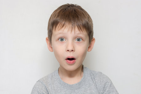 portrait of a very surprised boy. cute baby looking at the camera with surprised expression and open mouth. Horizontal photoの写真素材