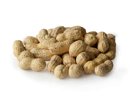 Peanuts in shells lie on a white background. Horizontal photo, close-up.