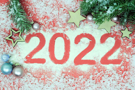The number 2022 is written by Muka on a red background. Good New Year spirit. Horizontal photo.の写真素材
