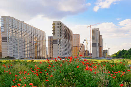 construction of high-rise apartment buildings. Construction with the help of cranes of a new...