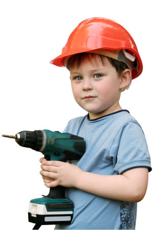 the boy is standing with a screwdriver in his hands in an orange helmet. Isolated on white background, vertical photo, Preschooler playing builder or repairman working with tools.の写真素材